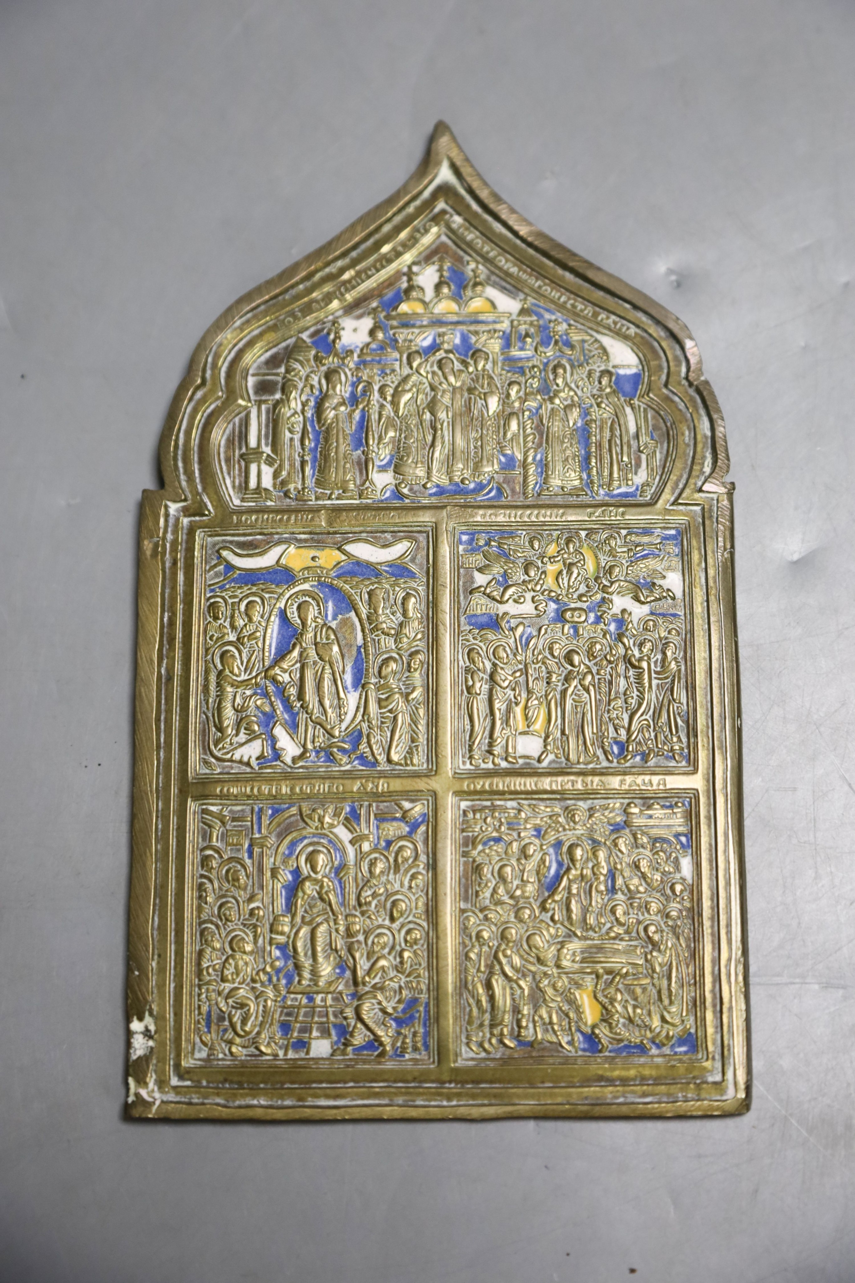 A Russian base metal oklad icon and a similar enamelled bronze panel, once part of a tryptich 27x23cm